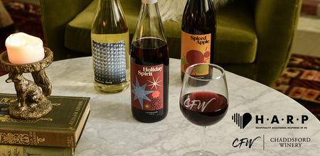 Holiday Cheer Wine Pack bottles on a table with HARP and Chaddsford Winery logos stacked in the lower right corner 